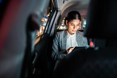 Woman dressed in business attire in a taxi - Photo
