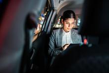 Woman dressed in business attire in a taxi - Photo