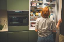 Woman choosing food from a frifge