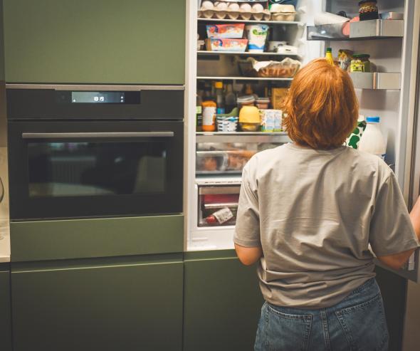 Woman choosing food from a frifge